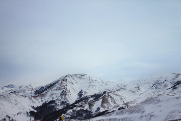 Fototapeta na wymiar View of snowy Caucasian mountains in Bakuriani ski resort 