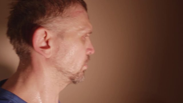 Very sweaty head of white adult man exerciser climbing stairs. Close-up view