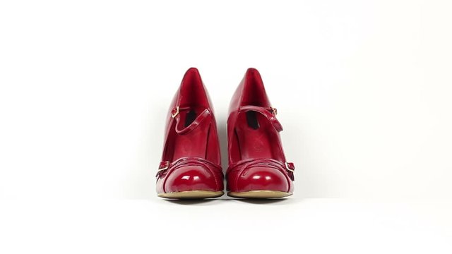 Red high heel shoes coming into Focus - Tracking shot on White Background. Stock Video Clip Footage - Front view