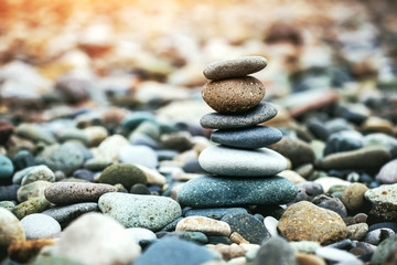 Sea pebble stones tower on beach. Balance and harmony concept