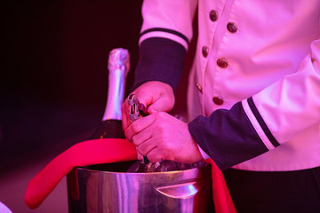 Opening a wine bottle with corkscrew in a restaurant 