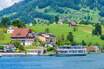Fototapeta na wymiar Small boat sailing on Lucerne lake, Switzerland.