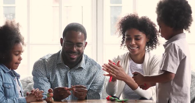 African american parents and kids sculpting playdough at home