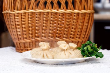 cooked khinkali on a white Cup on a serving table