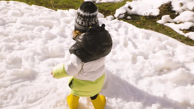 A little baby boy, toddler is playing with his father building a snowman in a beautiful snowy landscape of Guadarrama mountains in a town of Rascafria near the Spanish capital Madrid in winter. 