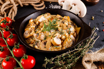 Mushrooms in cream sauce, julienne, champignon, products for cooking on the background of shale black Board