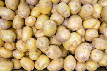 new potatoes texture. new potatoes on market table closeup photo.