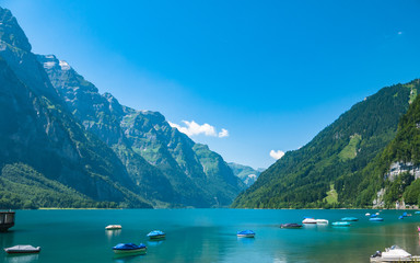 Stunning panorama view of Kloental lake (Kloenthalsee) and Bruennelistock (Brunnelistock) and Swiss Alps on a sunny summer day with blue sky cloud in background, Canton of Glarus, Switzerland