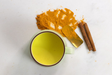 Turmeric drink with Milk,Healthy golden drink with Turmeric powder and cinnamon. Top view