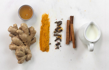 ingredients for turmeric latte (golden milk) . Ground turmeric, curcuma, cinnamon, ginger, honey,...