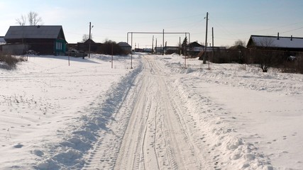 Russian road in the winter. Winter road in the village. Winter landscape in the village shot from a quadcopter