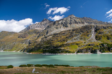 Beautiful lake beneath the mountain peaks of the Austrian alps on a sunny day