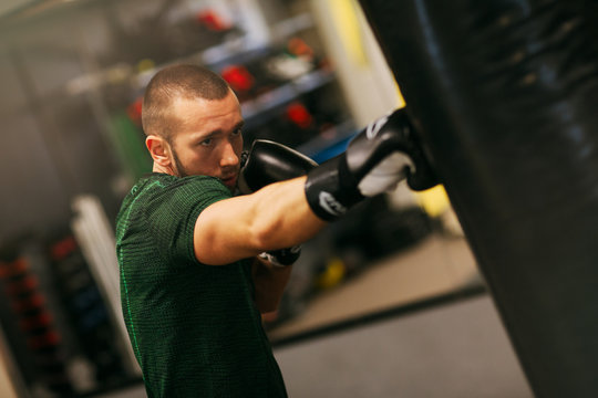 Image of fit strong sports man boxer make exercises in gym