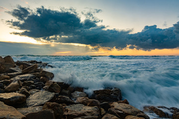 Seascape on rocky shore in storm