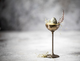 Easter composition quail egg in vintage stand.
