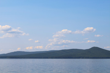 Beautiful lake, mountains and clouds. Picturesque landscape. Background. Panorama.