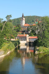 Fototapeta na wymiar old monastery reflecting on the water surface on sunny summer day in Sazava, Czech Republic