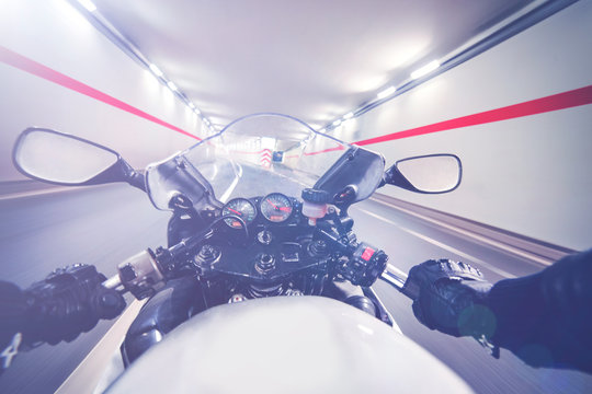 Point of view driving a motorcycle in a tunnel 