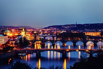 Panoramic view over Prague's bridges architecture and Vltava river city attractions at dusk 