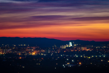 Beautiful sunset sky over the evening city