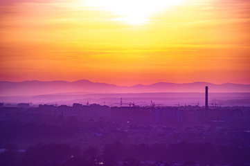 Beautiful sunset sky over the evening city