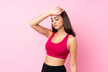 Young sport girl over isolated pink background with tired expression