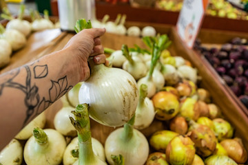 Full frame close up of a bunch of onions. Natural daylight. For wallpaper or background use. Organic vegetables at the local food market.