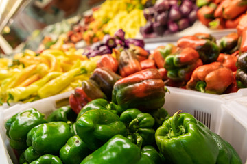 Close up of beautiful colored peppers of different colors. Green, orange, red and yellow peppers.Organic produce at the local food market.