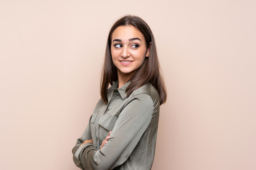 Young girl over isolated background with arms crossed and happy