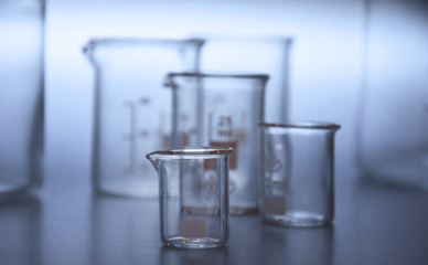 Glass beaker set stock images. Glass Measuring Beaker. Laboratory beaker collection. Glass laboratory equipment. Laboratory accessories stock images. Chemical background stock images