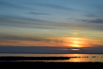 sunset at sea, coastal estuary akhtari in winter