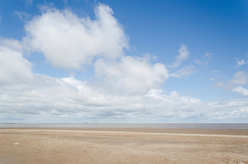 Fototapeta na wymiar Generic beach landscape, empty; sand and a sunny sky with some clouds