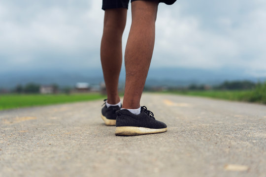 Sport shoes,Young black runner man running on the street be exercise and workout in nature countryside road in the morning. Healthy body exercise sports concept.