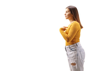 Profile shot of a young serious female pointing to herself