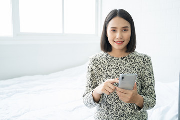 Selfie mania! Excited,Young attractive Asian woman making selfie on a smartphone camera or recording video vlog on a mobile phone. popular vlogger smiling to followers communicating by webcam online