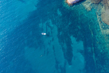 top view of jacht in turquoise water in Gran Tarajal, Canary islands, Fuerteventura, Spain. Aerial drone view in october 2019