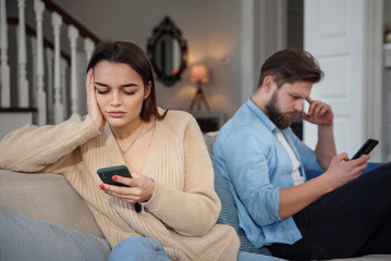Couple on the couch after an argument at home in the living room
