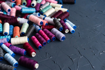 A lot of sewing colored thread. Thread reels. Colorful threads in the box. Texture of sewing...