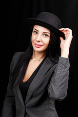 Fototapeta premium Beautiful woman portrait with a big hat. Vintage look. Fashion makeup. The hat covers half the face
