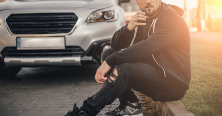 Young handsome man smoke with vape in vehicle