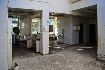 Abandoned and ruined kitchen of closed factory canteen or restaurant