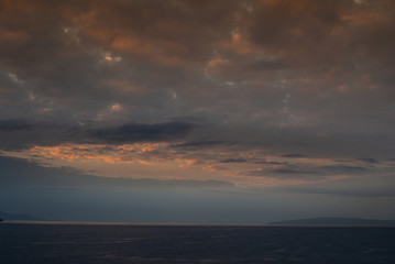 Lahaina, Maui, Hawaii, USA. - January 12 2012: Early morning light over ocean with fog near west side of the island, produces a dark cloudscape with parts as if set on fire.