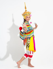 Young lady wearing Thai Tradition southern costume and put  headdress on her head,showing basic pattern folk dance,black shadow reflection on white background