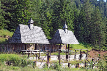 Two places for rest with roof shelters and picnic tables in the edge of forest. Big rustic looking wood gazebos