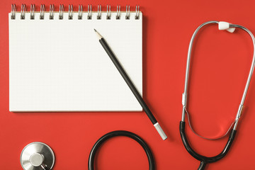 Stethoscope on a red table, concept medicine