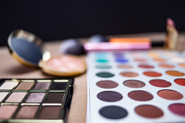 Makeup studio with all the accessories such as shadow palettes, concealers, makeups, eyeliners, brushes, lipstick and highlighter