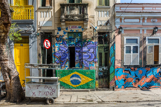 An Urban Street With A Downtown Grungy Feel In The Lapa Neighbourhood In Central Rio With Empty Hot Dog Stand Next To The Pavement In Brazil, South America