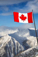 Kicking Horse, Golden, British Columbia, Canada. Beautiful Aerial View of Canadian Mountain Landscape during a vibrant sunny and cloudy morning sunrise in winter. Flag Composite