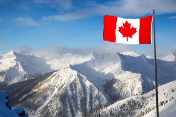 Kicking Horse, Golden, British Columbia, Canada. Beautiful Aerial View of Canadian Mountain Landscape during a vibrant sunny and cloudy morning sunrise in winter. Flag Composite