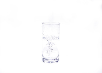 Pouring fresh healthy water into glass on white background.